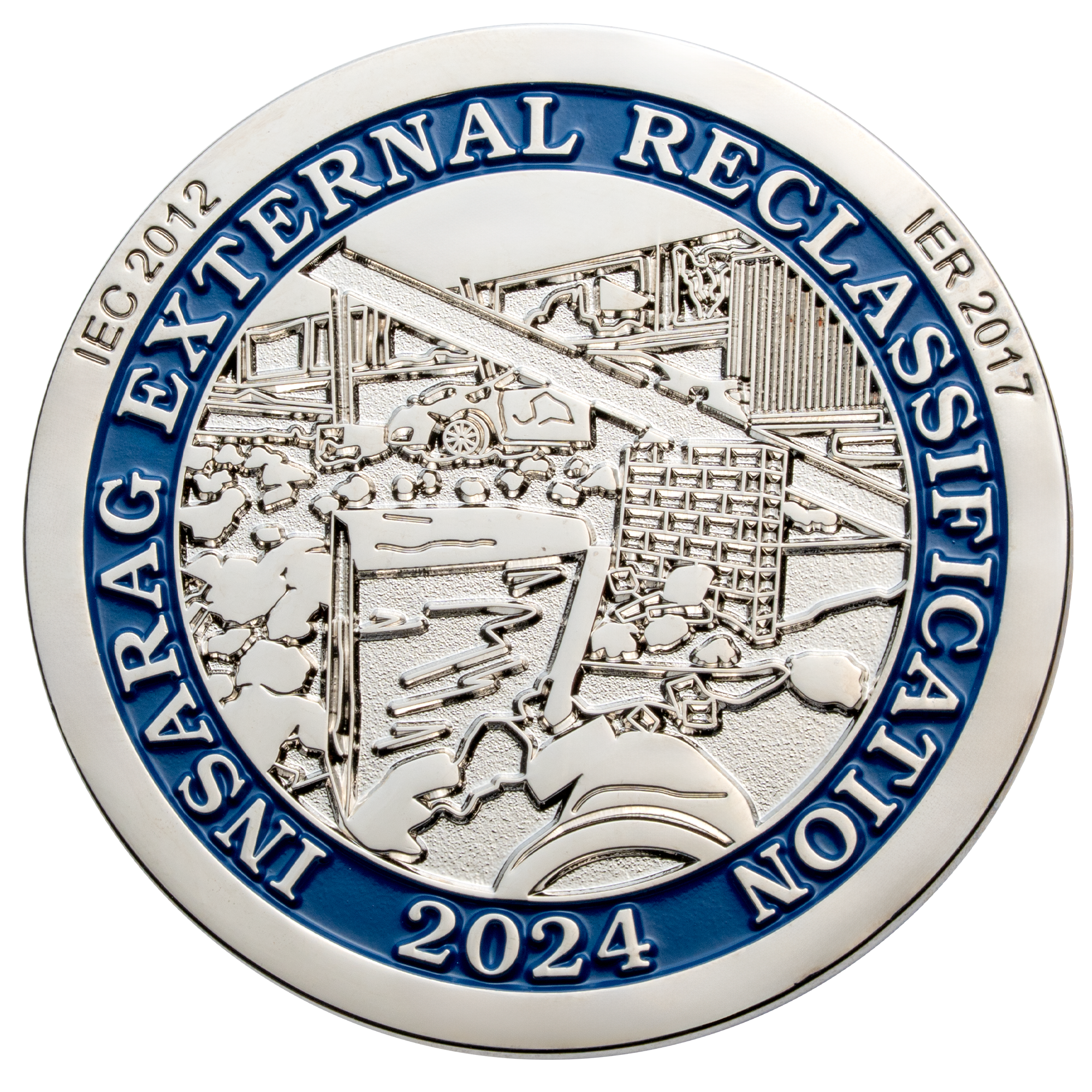 Silver challenge coin featuring blue enamel border with INSARAG External Reclassification 2024 text and detailed relief of rescue equipment.