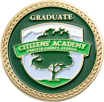 Citizens' Academy Forsyth County Georgia graduate challenge coin with green enamel, a tree emblem, and a gold rope-pattern border.