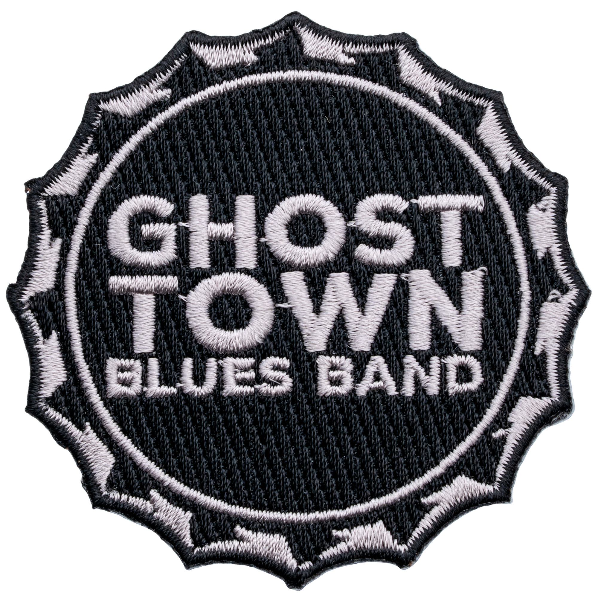 Circular embroidered patch for Ghost Town Blues Band featuring white text on a black background with a jagged edge border.