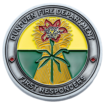 Dundurn Fire Department challenge coin featuring a red flower over a yellow wheat sheaf and green field with maple leaf icons.