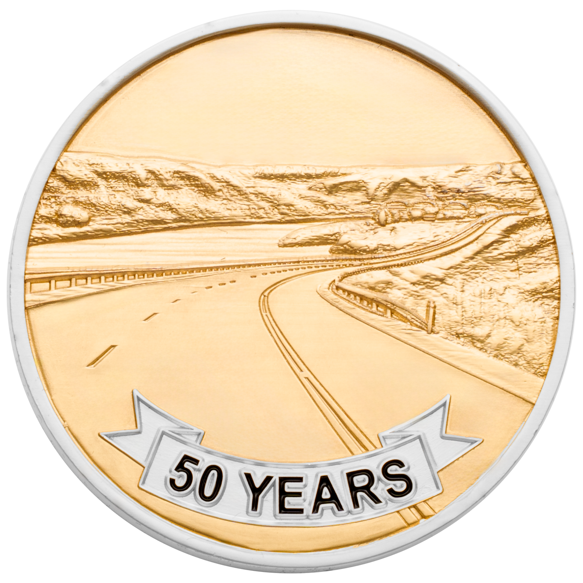 Gold and silver challenge coin featuring a 50 years banner and an embossed winding highway through a mountain landscape.