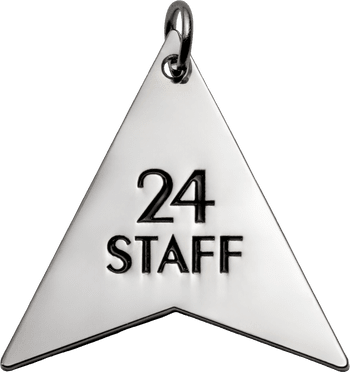 Arrowhead-shaped silver pendant keychain with black engraved text reading 24 STAFF.