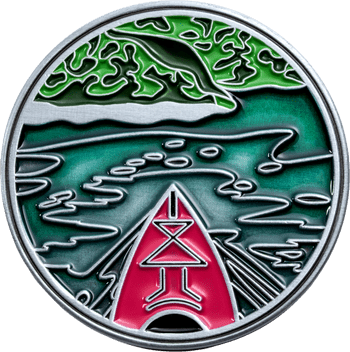 Round silver challenge coin featuring a stylized red kayak bow on green enamel water facing a shoreline.