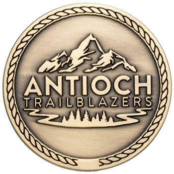 Antiqued bronze round medallion featuring the Antioch Trailblazers logo with a mountain range, pine trees, and a braided rope border.