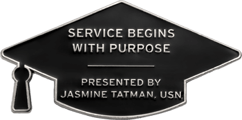 Graduation cap shaped challenge coin with black enamel and silver lettering reading Service Begins With Purpose.