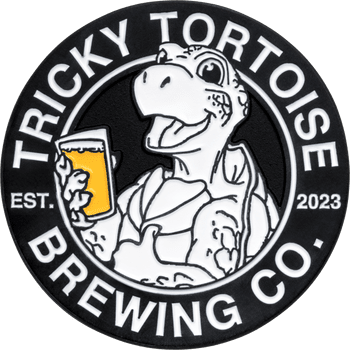 Circular challenge coin featuring Tricky Tortoise Brewing Co. logo with a cartoon tortoise holding a beer glass.