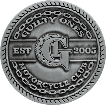 Antique silver motorcycle club challenge coin featuring Guilty Ones Motorcycle Club Est 2005 with chain and gear border details.