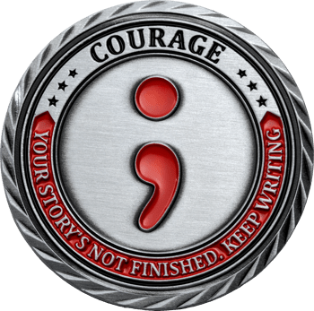 Silver challenge coin featuring a red semicolon symbol and text that reads Courage and Your Story's Not Finished, Keep Writing.
