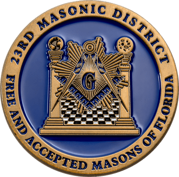 23rd Masonic District challenge coin with Square and Compasses symbol against a blue enamel background and gold rim.