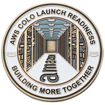Enamel challenge coin featuring AWS Colo Launch Readiness text, Amazon logo, and a stylized server room hallway design.