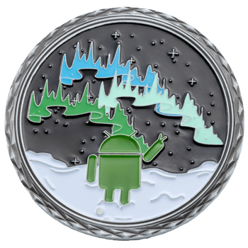 A circular challenge coin featuring a green Android mascot under a blue and green aurora borealis sky with a diamond-cut silver border.