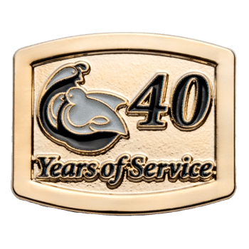 Gold rectangular lapel pin with black text reading 40 Years of Service and a grey and black bird emblem.