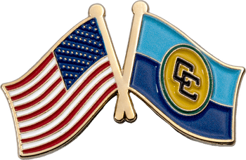 Enamel lapel pin featuring crossed flags of the United States and a two-tone blue flag with a monogram emblem.