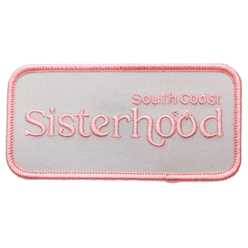 Rectangular embroidered patch with South Coast Sisterhood text in pink thread on a light grey background with a pink merrowed border.