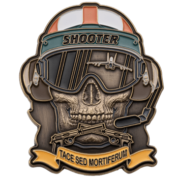 Skull-shaped challenge coin wearing a flight helmet and goggles with a fighter jet reflection and crossed pistols.